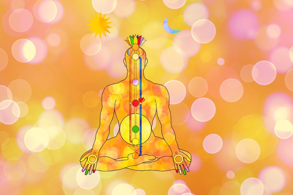 Yogi meditating with awakened kundalini flowing through chakras